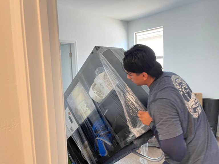 Aaron Movers employee moving a dresser