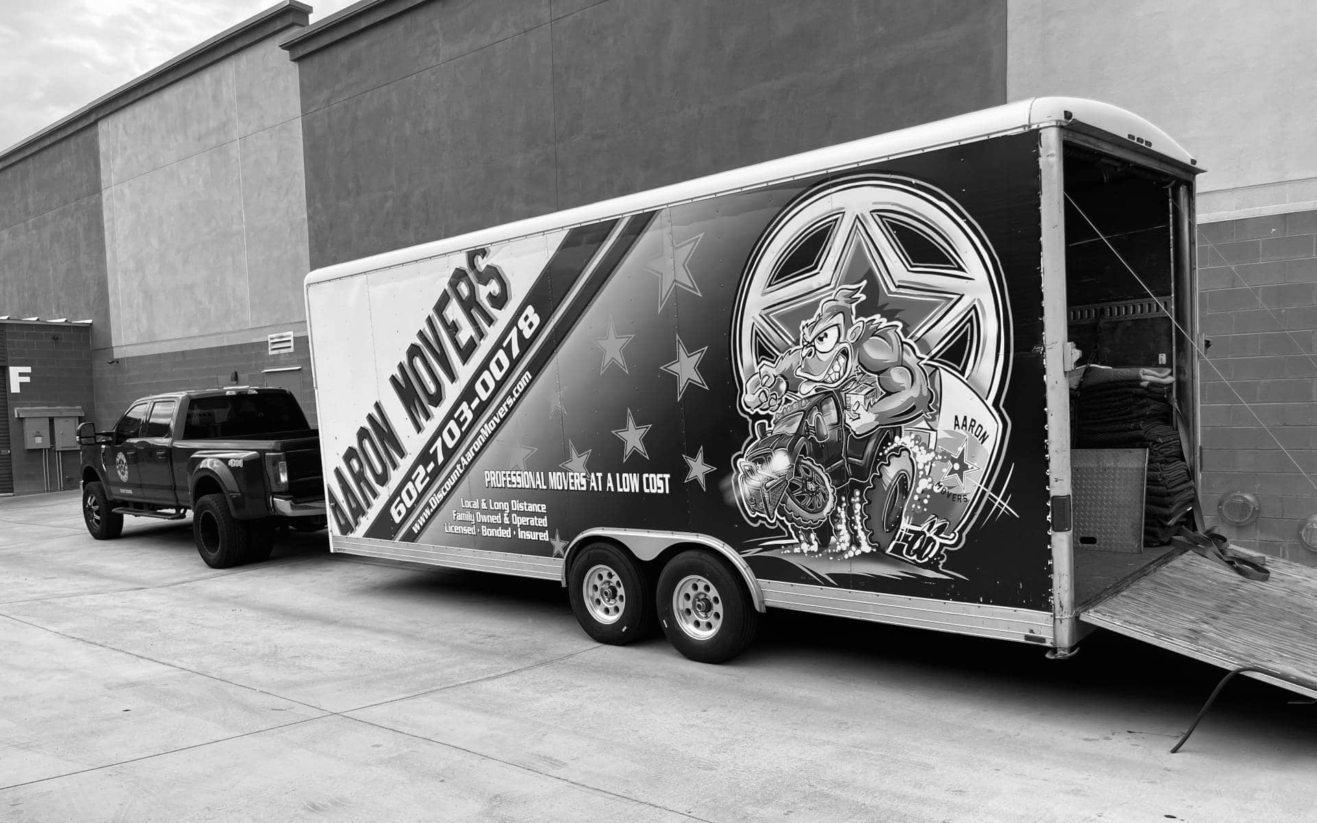 Aaron Movers truck and trailer in black and white