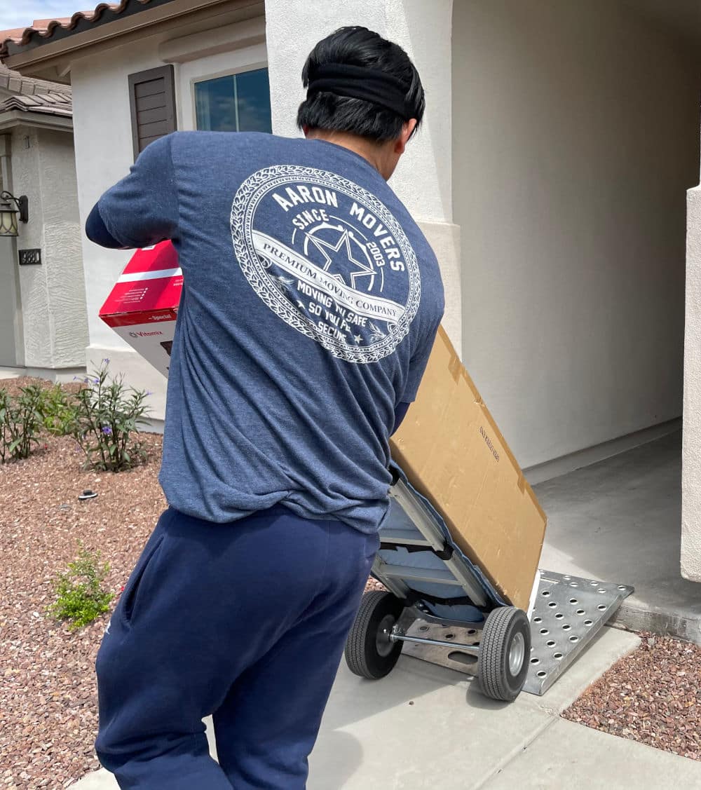 mover moving boxes on a dolly